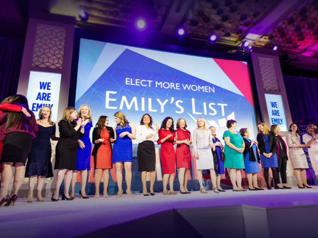 An image of EMILYs List candidates in a lineup, presenting at their 2018 conference.