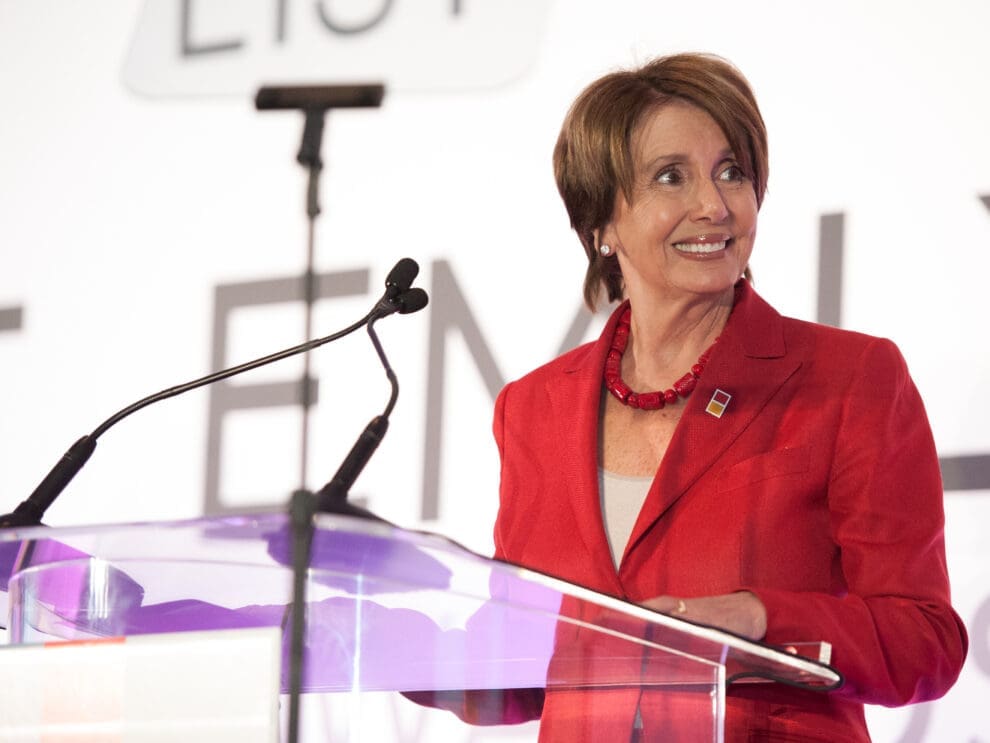 Image of Nancy Pelosi, speaking at a podium.