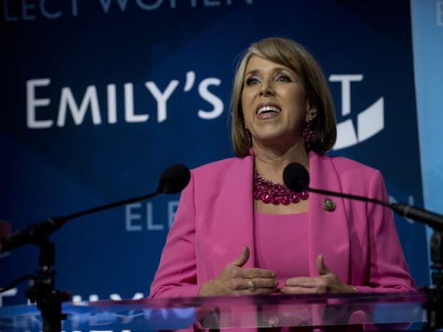 Image of Michelle Lujan Grisham speaking at a podium.